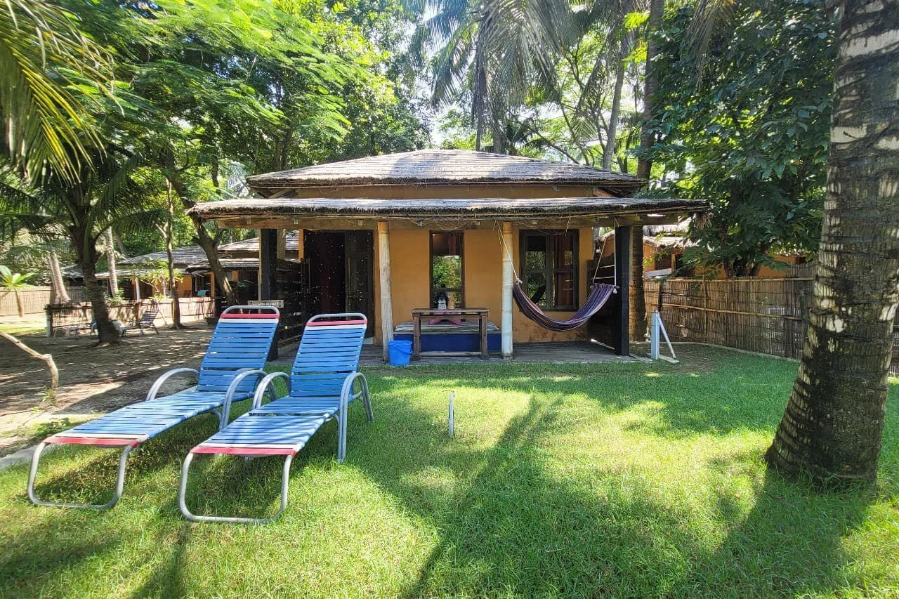 A garden bungalow beneath palms